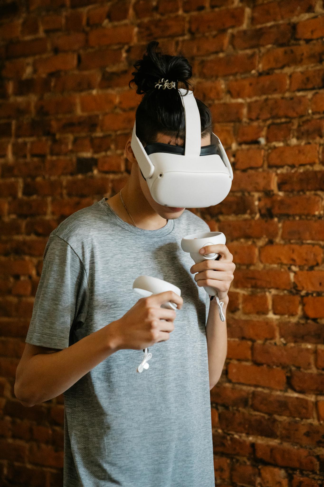 Young adult with VR headset playing a virtual reality game indoors.